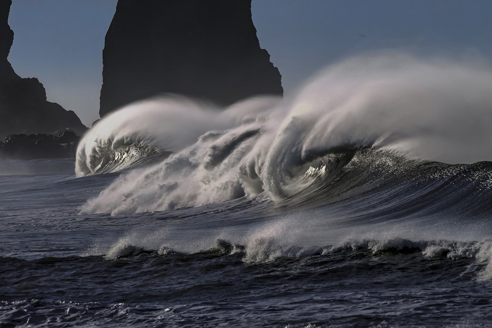 Crashing waves with Rock Outcrop behind